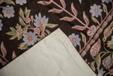 Detail of chainstitch floral design on dark brown, revealing the stitched cotton canvas backing.