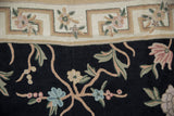 Curvilinear Arts and Crafts style chainstitch carpet featuring floral vines, geometric border, black, beige.