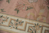 Chainstitch rug detail with rose Arts and Crafts inspired curvilinear florals and ivory border.