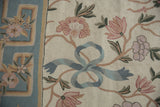 Spiraling chainstitch texture with blush florals, slate blue ribbon, and geometric border.
