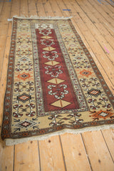 Full length perspective of a vintage Melas runner with copper, beige, and brown geometric patterns.