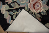 Black vintage chainstitch carpet, showing blush and celadon floral detail with ivory cotton canvas backing.