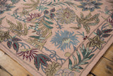Detailed chainstitch texture with curvilinear floral patterns in soft pink, blue, and green.