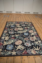 Intricate William Morris inspired curvilinear floral pattern on the vintage chainstitch rug, featuring black, blue, rose, and green hues.