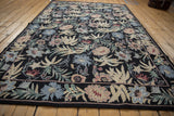 Detail of vintage chainstitch carpet, showing curvilinear floral patterns in dusty blush and denim blue.