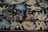 Curvilinear floral and vine patterns in dusty rose, seafoam green, and denim blue chainstitch.