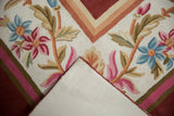 Folded vintage chainstitch carpet shows colorful floral design, plush pile, and cotton canvas backing.