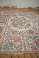 Pastel curvilinear floral sprays in trellis pattern on vintage chainstitch carpet.