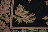 Traditional chainstitch curvilinear floral design with dusty mauve, olive green, and striped border.