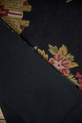 Black cotton canvas backing stitched to a vintage chainstitch carpet with floral motifs.