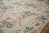 Vintage chainstitch rug detail with pink ribbon and delicate curvilinear floral bouquet.