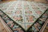 Curvilinear chainstitch corner: ivory field, blush floral sprays, blue trellis, navy border.