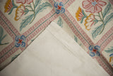 Curvilinear floral patterns and linear borders on a vintage chainstitch rug with cotton canvas backing.