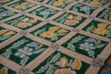 Vintage Chainstitch Carpet detail: emerald green field, pink lattice, blue and yellow florals.