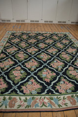 Curvilinear floral border on vintage chainstitch rug with blush, powder blue, olive green motifs.