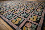 Dusty mauve trellis framing floral sprays and vines on a vintage chainstitch carpet.