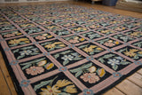 Dusty mauve lattice framing curvilinear floral motifs on a vintage chainstitch carpet.