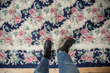 Curvilinear blush, ivory, cobalt blue floral pattern on vintage chainstitch rug.