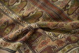 Textured hand-knotted Melas rug with rust, olive, and ivory reciprocating patterns.