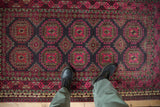 Vintage Daulatabad rug corner showcasing multi-tiered borders and ornate fuchsia guls.