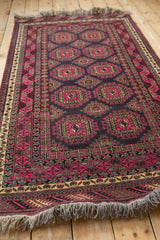 Daulatabad rug border with germinating plant motifs, meandering vines, and fuchsia guls.