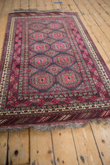 Ornate guls, meandering vines, and fringed border on a vintage Daulatabad rug in fuchsia, charcoal, and silver.