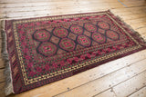 Daulatabad rug corner: fuchsia guls, multi-tiered borders with floral blossom and vines.