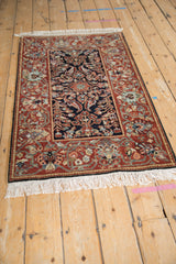 Vintage Armenian Hamadan rug seen from an angle, highlighting the plush pile and floral borders.