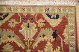 Corner of a vintage Sultanabad rug showing the plush wool pile, terracotta palmettes, and ivory fringe.