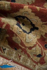 Corner view of the vintage Armenian rug's plush, full pile and original ivory fringe.