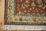 Corner view of the vintage Armenian rug's full pile, floral borders, and clean ivory fringe.
