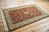 Full angled view of a hand-knotted Armenian Lilihan rug highlighting its copper and ivory floral pattern.