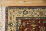 Corner of a vintage Armenian rug showing the full wool pile, intact selvage, and ivory fringe.