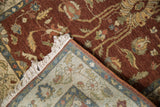 Corner detail of a vintage Armenian rug showing its hand-knotted back, pile, and ivory fringe.