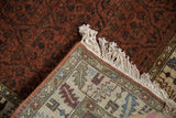 Folded corner reveals the fine hand-knotted construction and ivory fringe of a vintage Armenian rug.