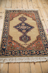 An angled view of the vintage Armenian Serab rug, displaying its full wool pile and geometric design.