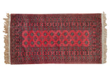 Vintage Daulatabad rug with columns of geometric guls on a dusty raspberry field with charcoal borders.