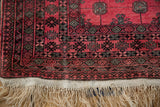 Secured end of the vintage Daulatabad rug showing its hand-knotted ivory fringe and geometric borders.
