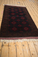 Original white fringe, a secured end, with cherry red and dark brown geometric patterns.
