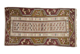 Vintage Melas rug with geometric floral arrangements in moss green, pale plum, and silver tones.