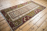 Corner view of a vintage Turkish Melas rug highlighting the intact side cord selvage and full pile.
