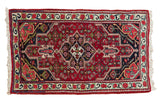 Vintage fine Bijar rug with a geometric shield medallion in sapphire blue and gem-like ruby red.