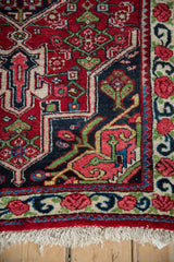 A fine vintage Bijar rug's corner showing the geometric spandrel, floral border, and clean fringe.