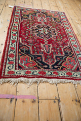 A low angle on a fine vintage Bijar rug, showing the dense pile and geometric Herati design.