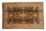Hand-knotted Indian Oushak carpet with gold and beige floral palmettes over a chocolate brown field.