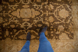 Plush wool pile of an Oushak design carpet with gold and beige floral palmettes.