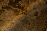 Soft, plush wool pile with a silk-like luster on a folded gold and brown Oushak carpet.