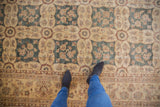 Dusty teal Peshawar carpet with wheat floral bouquets and a vine palmette border.