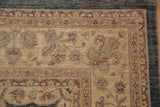 Peshawar carpet corner showing dusty aqua blue selvage, wheat field, and palmette border.