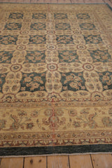 Peshawar carpet detail with dusty teal field, panel floral bouquets, and vine-palmette border.